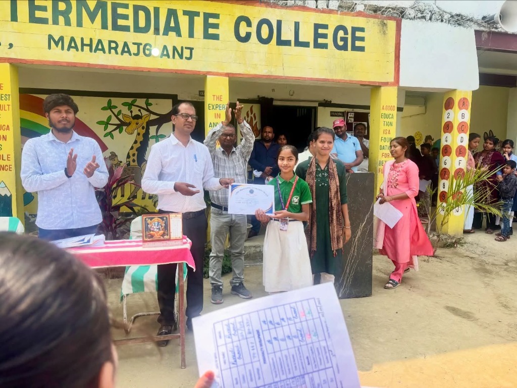 Student receiving certificate from teachers on stage