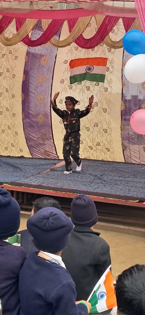 Student performing patriotic dance in army dress on stage