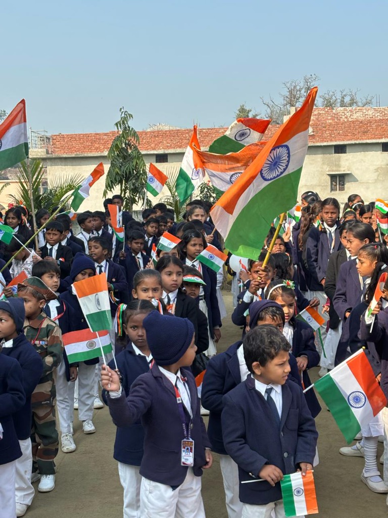 Students waving Indian tricolor flags during a national parade