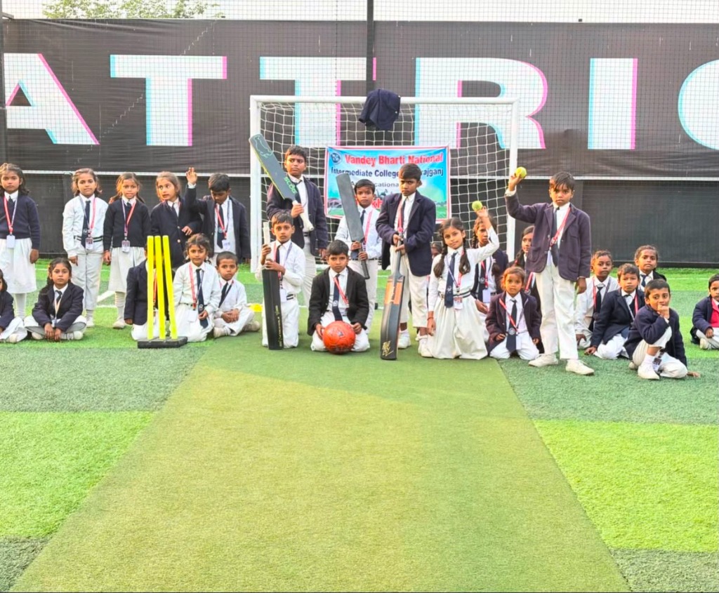 Wide group photo of students and players on turf with school sports banner